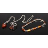 A collection of silver and amber jewellery. To include pendant on chain, bracelet and ring.