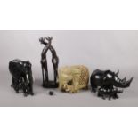 Five carved animal figures. To include an elephant and calf, Rhino and calf, a pair of Giraffes
