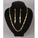 A 9ct Gold jewellery suite, including necklace and tassel earrings. Total weight: 13.52g