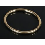A 9ct Gold filled hinged bangle. Stamped 375 to the inside of the clasp. Diameter 7cm. Total weight: