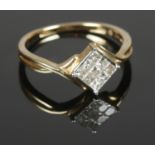 A 9ct gold ring set with 9 square cut diamonds within a square bridge. Approximately ½ct in total.
