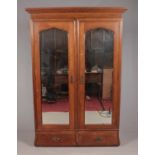 A Waring & Gillow oak mirror front double wardrobe raised over drawer base.