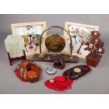 A collection of mostly wood oriental items. Includes framed hand fans, table gong, jade coloured