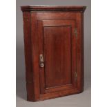 A Georgian oak corner cupboard. Comprising of three scalloped shelves and single door. H:109cm, W: