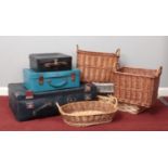 Three vintage suitcases & a quantity of wicker baskets.