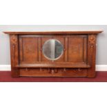 An oak top mantle from a fireplace. Comprising of an inserted circular mirror and carved design,