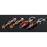 Two pairs of silver and amber pendant earrings. 12g.