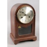 An early 20th century mahogany dome-top mantle clock. Movement stamped on the back, depicting