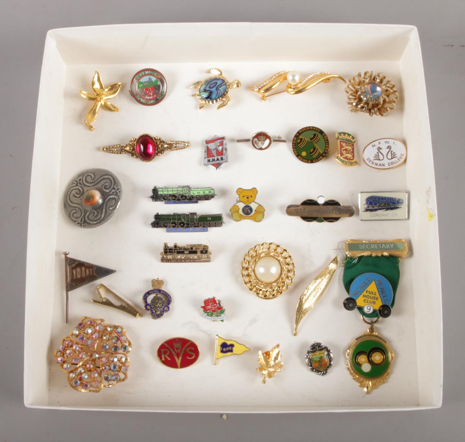 A selection of twenty nine vintage brooches and pin badges. To include LNER 'Mayflower', Royal