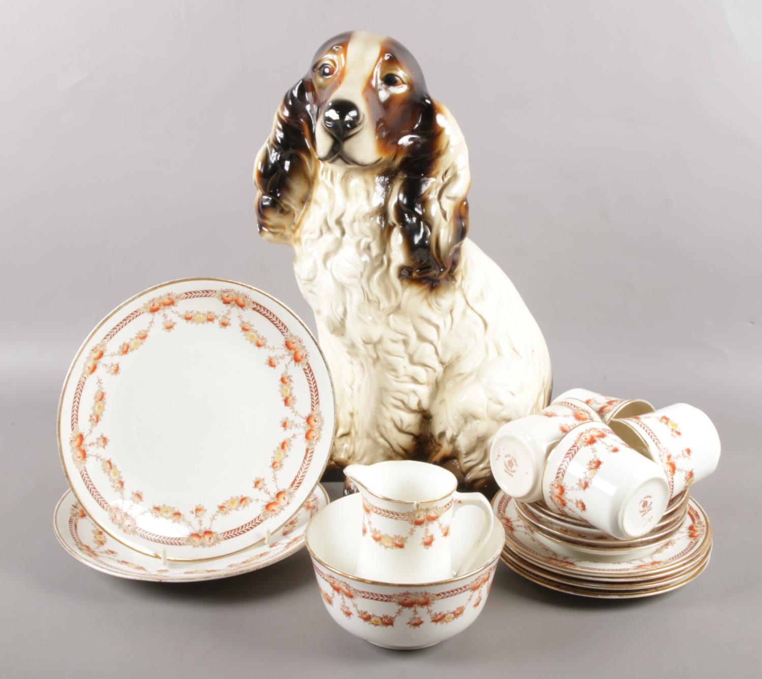 A Royal Albert bone china part tea set along with a vintage plaster figure of a spaniel.