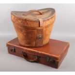 A Victorian top hat box along with a vintage suitcase.