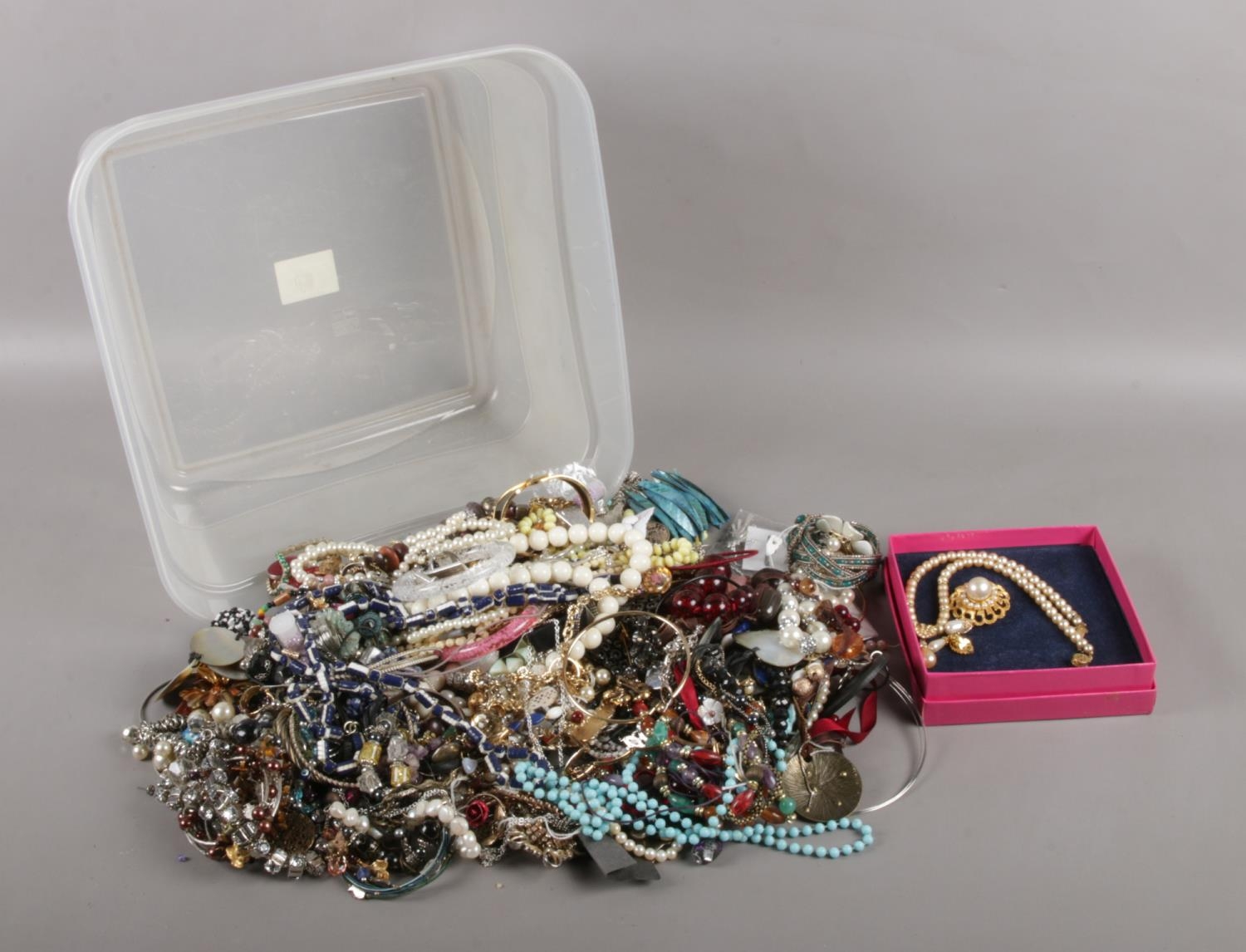 A box of assorted costume jewellery. To include brooches, necklaces, earrings and bracelets etc.