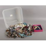 A box of assorted costume jewellery. To include brooches, necklaces, earrings and bracelets etc.