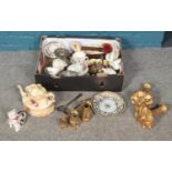 A box of miscellaneous. Including three graduated brass toby jugs, gilt curtain pole ends,