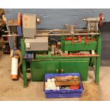 A wood turning lathe, complete with accessories and custom build cupboard containing hammers,