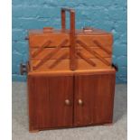 A mid twentieth century mahogany sewing cupboard, with lift-away cantilever box, with contents. 59cm