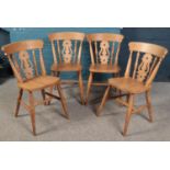 A set of four beech dining chairs.