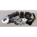 A camera bag with contents of photographic equipment. Includes Nikon D300 camera, Nikon D70