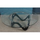 A retro style glass top coffee table. Diameter of top 120cm.