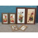 Six framed paintings on glass, depicting flowers.