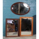 Three large wall mirrors. Includes Eugene advertising mirror, pine framed example and an oval