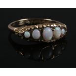 A 9ct gold five stone opal ring. Size Q. 1.96g.