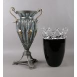 Two large glass vases. To include a metal and glass trophy vase and black and clear art glass