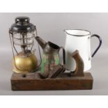 An assortment of items to include Tilley lamp, Castrol can, wood plane and an enamel jug.