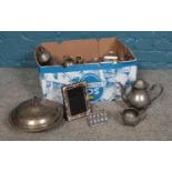 A box of assorted silver plate. Napkin rings, teapot, coffee pot, photo frame, lidded tureen etc