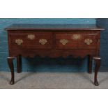 A Georgian style oak sideboard. Height 76cm, Width 124cm, Depth 47.5cm.