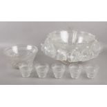 A large cut glass punch bowl, with smaller bowl and 18 cups. Replacement plastic spoon.