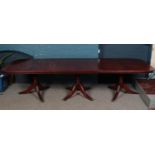 A large mahogany veneer three pedestal dining table. (320cm x 100cm)