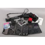A collection of photographic equipment. Includes Nikon SB-600 flash head, Slik monopod, camera