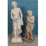 Two concrete and composite garden statues depicting women; one carrying fruit, the other draped in