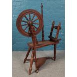 A 16" oak spinning wheel, with foot pedal.