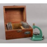 A wooden cased set of Dracip watch maker's tools.