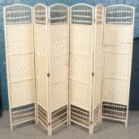 A wicker folding screen.