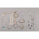 An assortment of costume jewellery. To include necklaces, bangles, brooches and Swarovski examples.