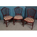 A set of eleven carved mahogany dining chairs. Some of the wood split and repaired.