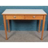 A pair of light oak side tables with painted top and single drawer along with matching table/desk.