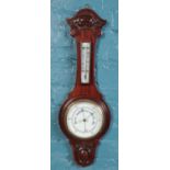 A carved mahogany banjo barometer.