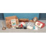 A box of miscellaneous. To include mantle clock, breadbin, games toys and postcards etc.