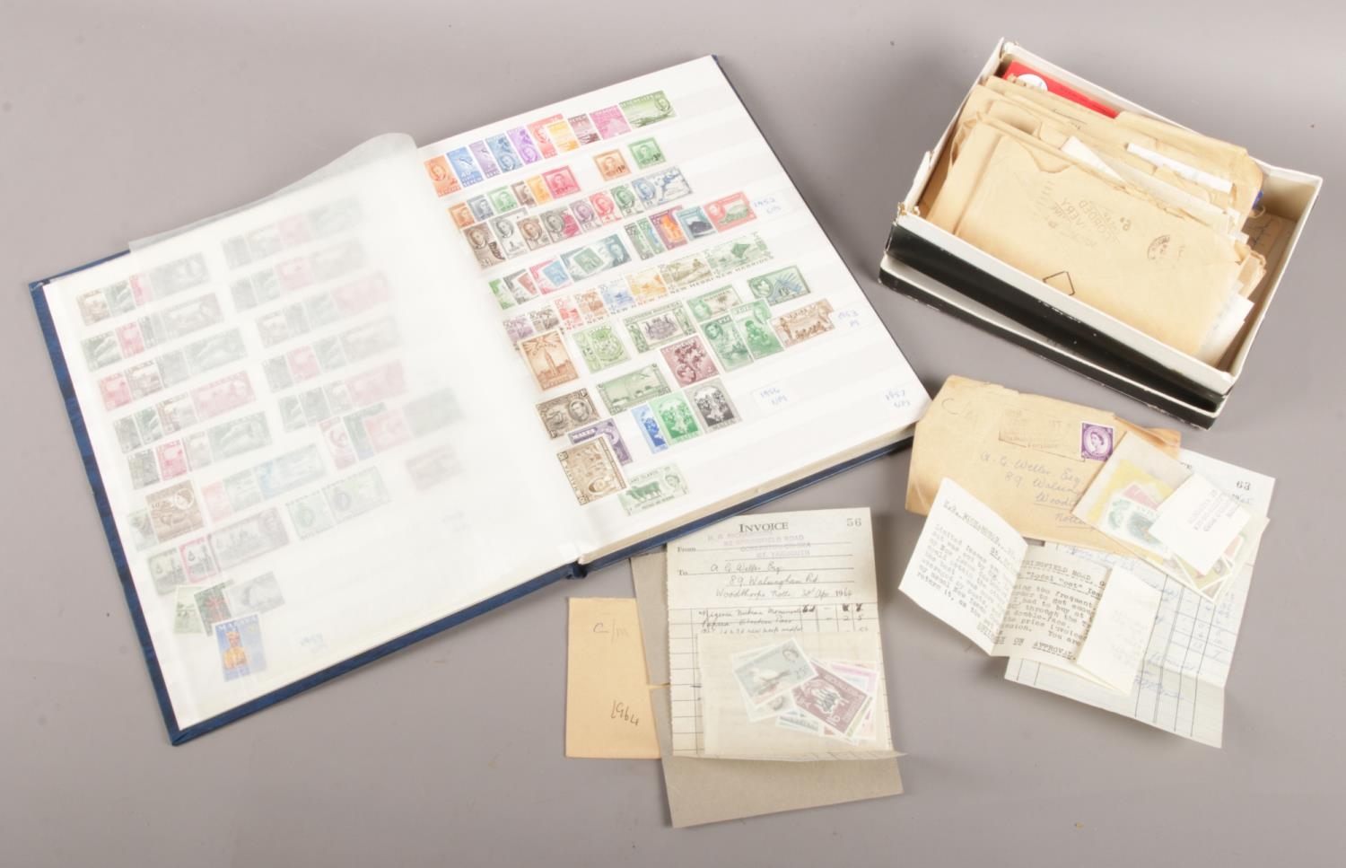 An album and collection of loose world stamps. The loose stamps all having original invoice