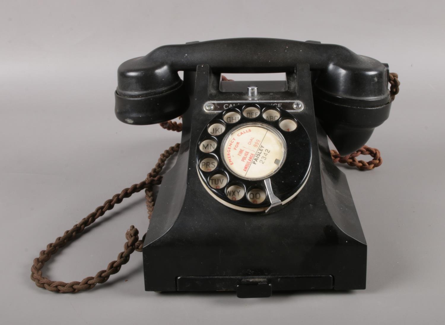 A Call Exchange bakelite telephone. (Model No 312L S53/3A) with pull out tray & braided cable.
