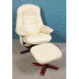 A cream leather easy chair and matching foot stool.