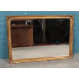 A large decorative gilt framed bevel edge wall mirror. 70cm x 101cm. Generally good condition.