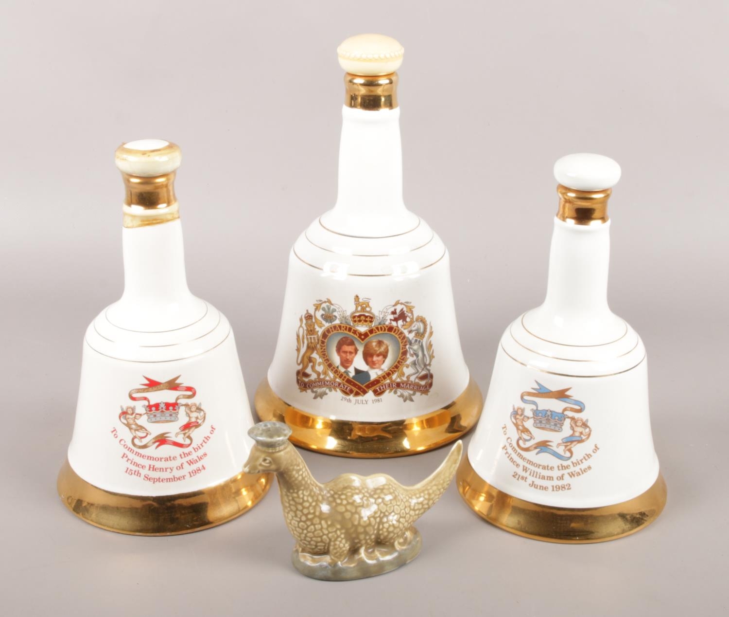 A collection of ceramic whisky decanters. Includes three Wade Bell's commemorative examples and a