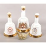 A collection of ceramic whisky decanters. Includes three Wade Bell's commemorative examples and a