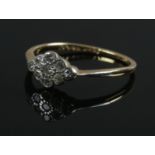 An 18ct gold, platinum and diamond cluster ring. Size N. 1.73g.