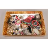 A large box of assorted costume jewellery. To include necklaces, bracelets and dress watches etc.